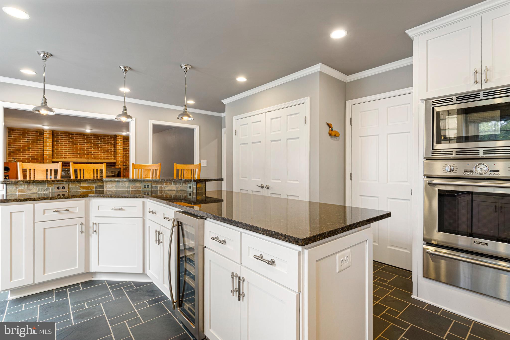 10904 Equestrian Court Reston, VA 20190 - Photo 15 of 81 a kitchen with stainless steel appliances granite countertop a stove a sink and a microwave