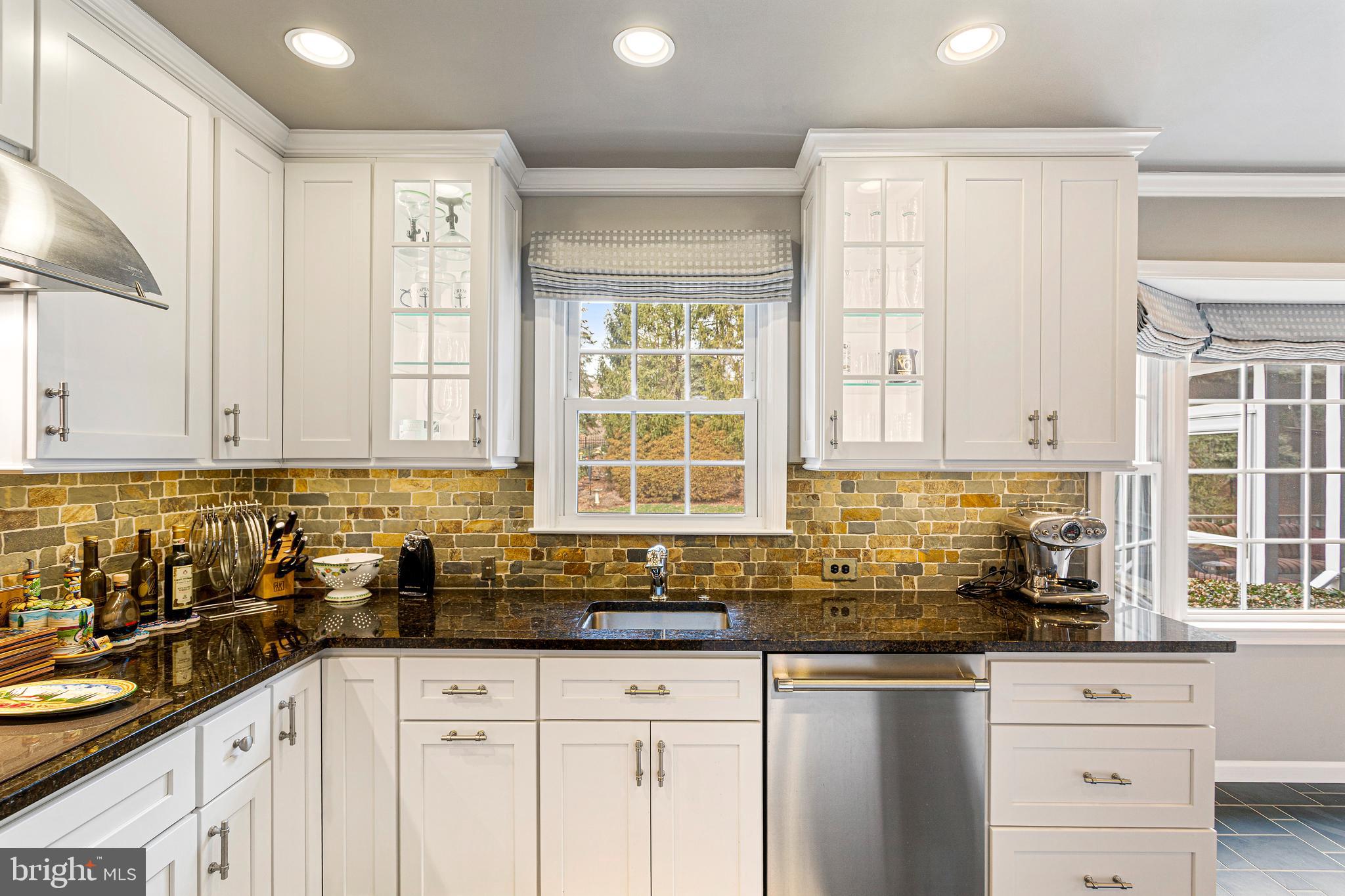 10904 Equestrian Court Reston, VA 20190 - Photo 20 of 81 a kitchen with granite countertop a sink a window and cabinets