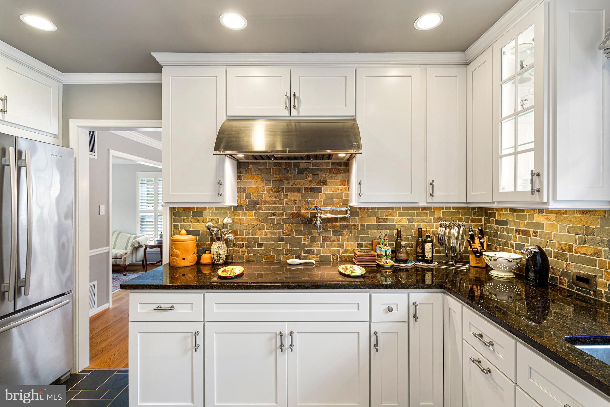10904 Equestrian Court Reston, VA 20190 - Photo 21 of 81 a kitchen with stainless steel appliances granite countertop a sink a refrigerator and cabinets