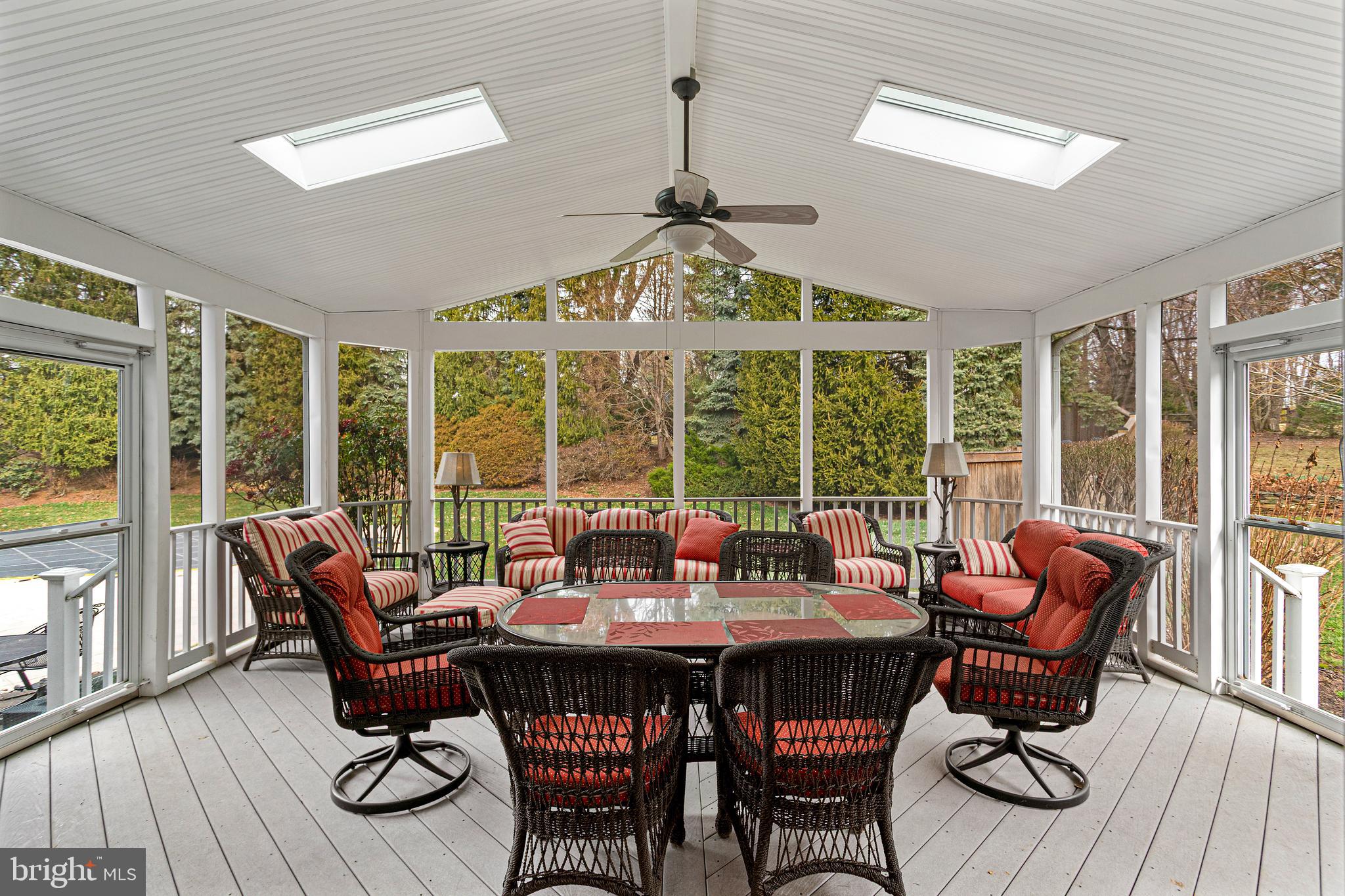 10904 Equestrian Court Reston, VA 20190 - Photo 25 of 81 a dining room with furniture large windows and wooden floor