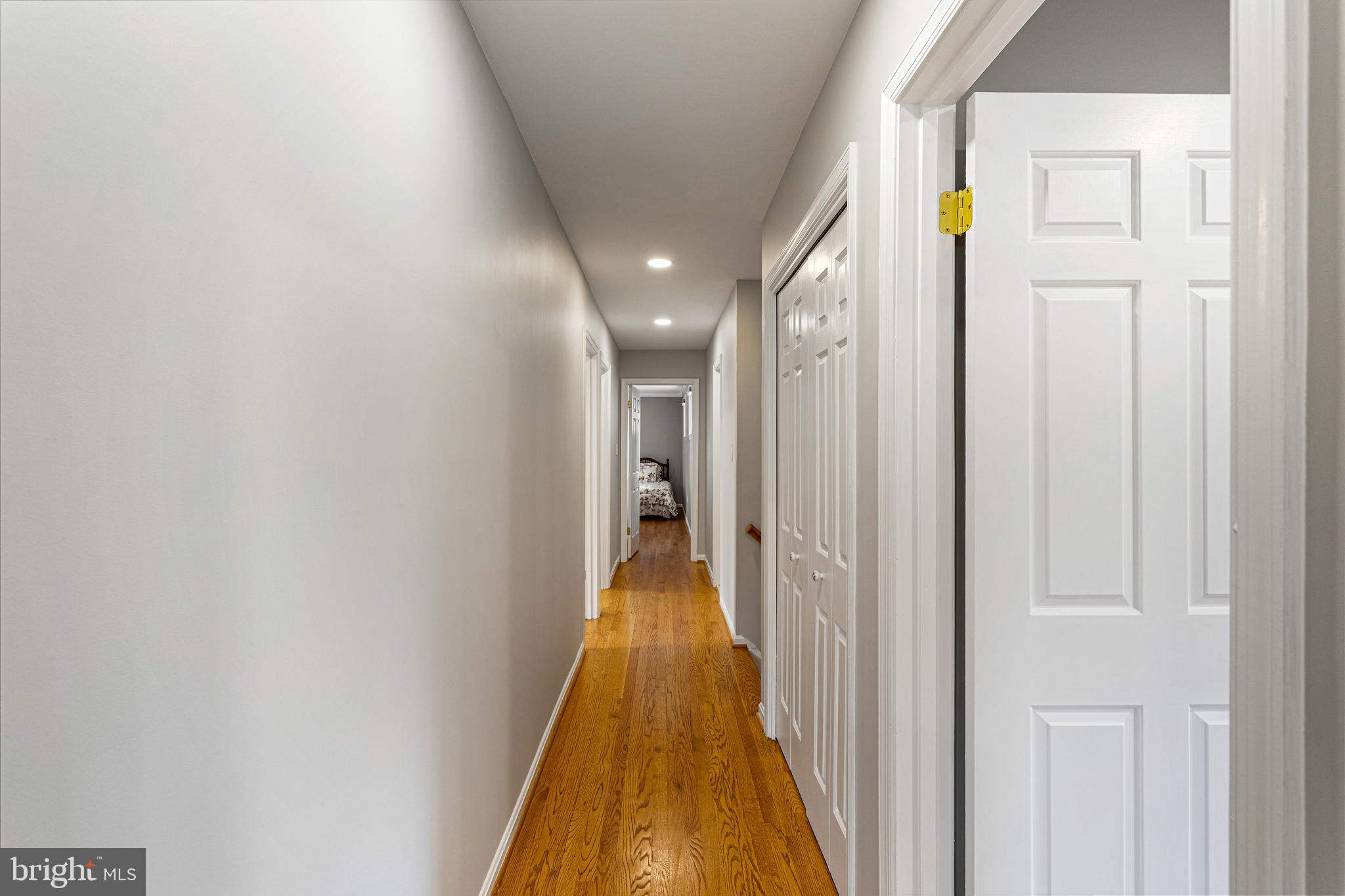 10904 Equestrian Court Reston, VA 20190 - Photo 41 of 81 a view of a hallway with wooden floor and a bathroom
