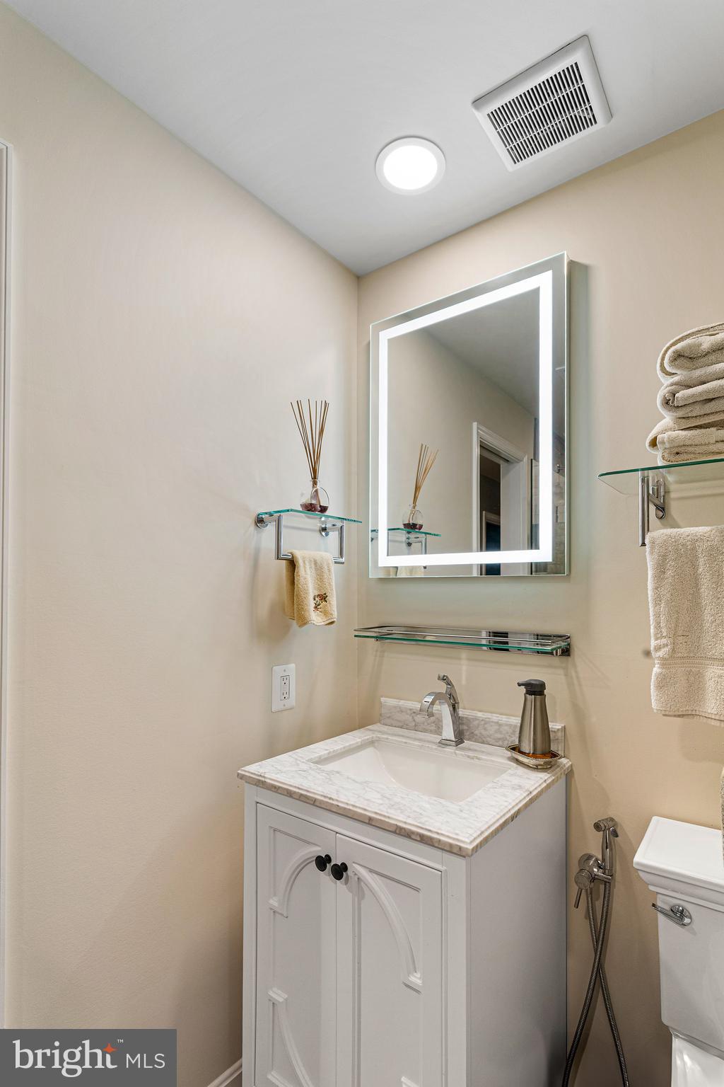 10904 Equestrian Court Reston, VA 20190 - Photo 57 of 81 a bathroom with a granite countertop sink and a mirror