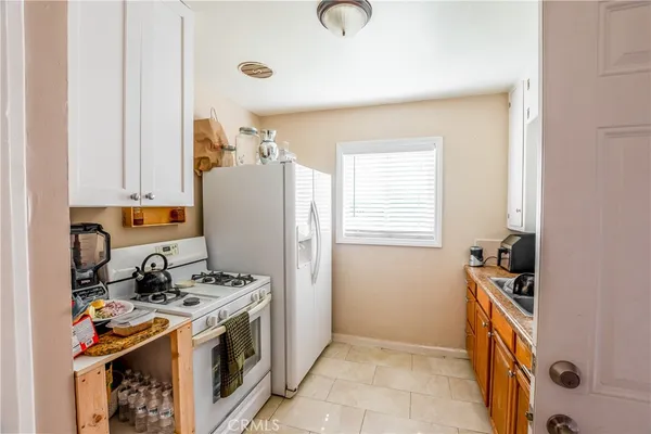 a kitchen with stainless steel appliances granite countertop a stove a refrigerator and a sink