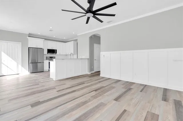 a view of a kitchen with wooden floor and staircase