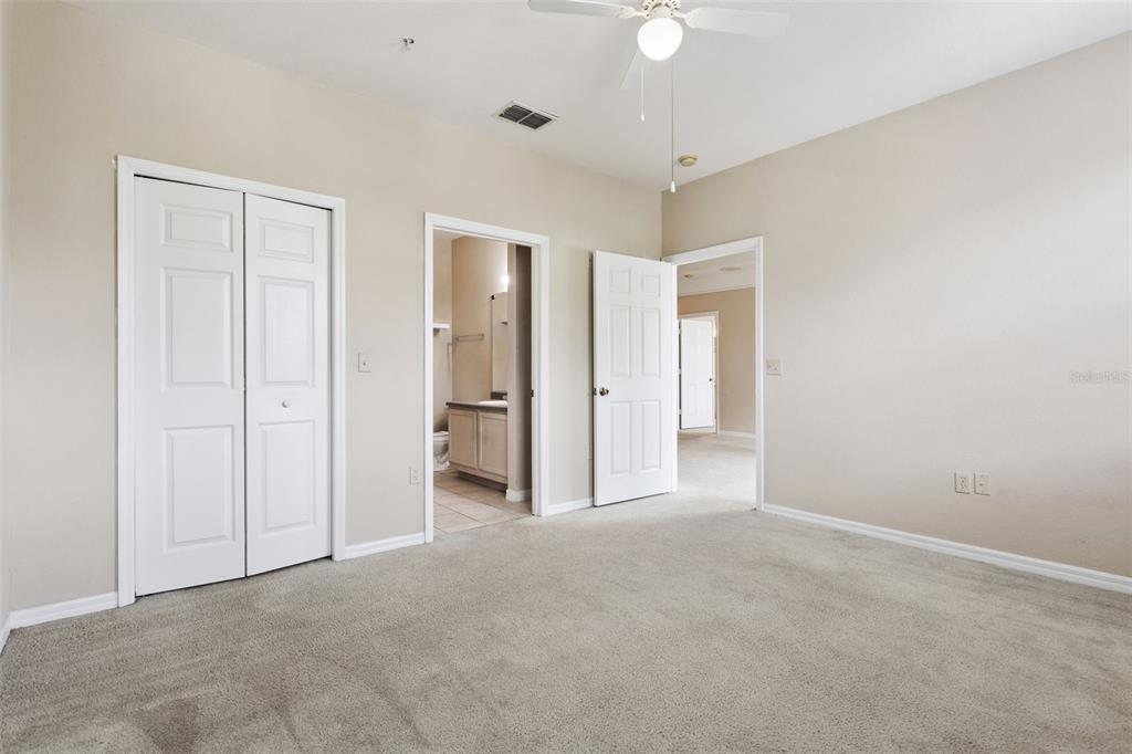 3446 Soho Street, Unit 303 Orlando, FL 32835 - Photo 14 of 47 an empty room with a fan & a ceiling fan
