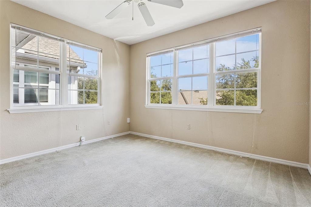 3446 Soho Street, Unit 303 Orlando, FL 32835 - Photo 17 of 47 an empty room with windows