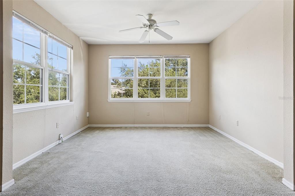 3446 Soho Street, Unit 303 Orlando, FL 32835 - Photo 18 of 47 an empty room with a window and a ceiling fan