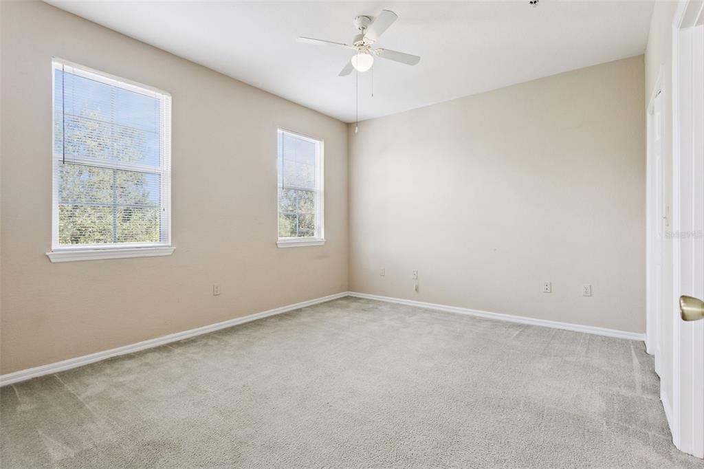 3446 Soho Street, Unit 303 Orlando, FL 32835 - Photo 19 of 47 an empty room with windows and fan