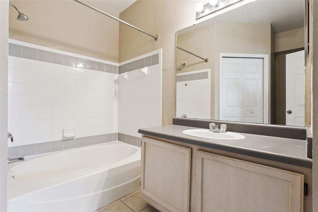 3446 Soho Street, Unit 303 Orlando, FL 32835 - Photo 21 of 47 a bathroom with a bathtub and a sink