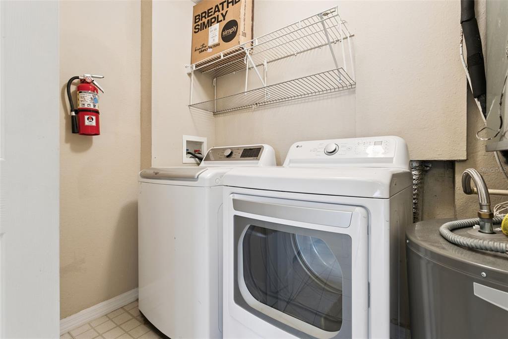 3446 Soho Street, Unit 303 Orlando, FL 32835 - Photo 24 of 47 a utility room with dryer and washer