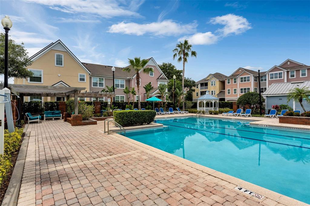 3446 Soho Street, Unit 303 Orlando, FL 32835 - Photo 47 of 47 a front view of a house with swimming pool yard and outdoor seating