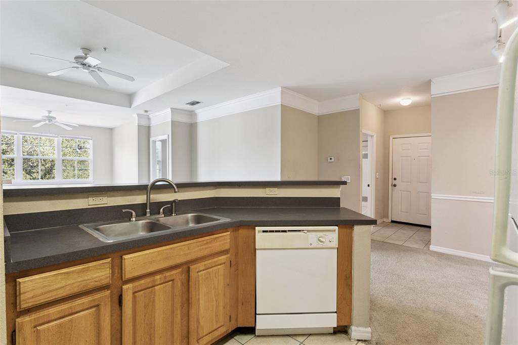 3446 Soho Street, Unit 303 Orlando, FL 32835 - Photo 10 of 47 a kitchen with a sink cabinets and window