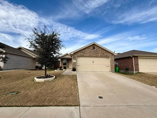 a view of a house with a yard and garage