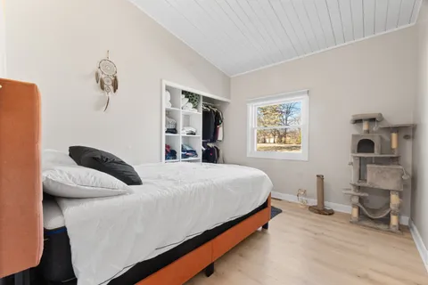 a bedroom with a bed and a potted plant