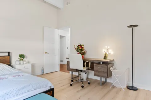 a bedroom with a bed and a window