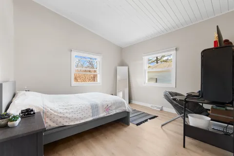 a bedroom with a bed and a night stand