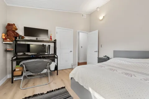 a bedroom with a bed and a potted plant