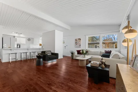 a kitchen with granite countertop a sink a stove and cabinets