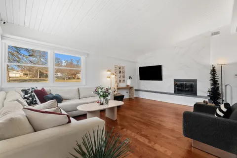 a view of a dining room with furniture wooden floor and a chandelier