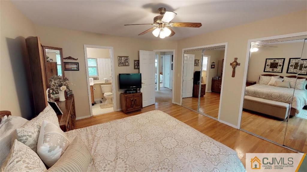 16 Sweet Gum Road Howell, NJ 07731 - Photo 13 of 21 a bedroom with furniture and a flat screen tv