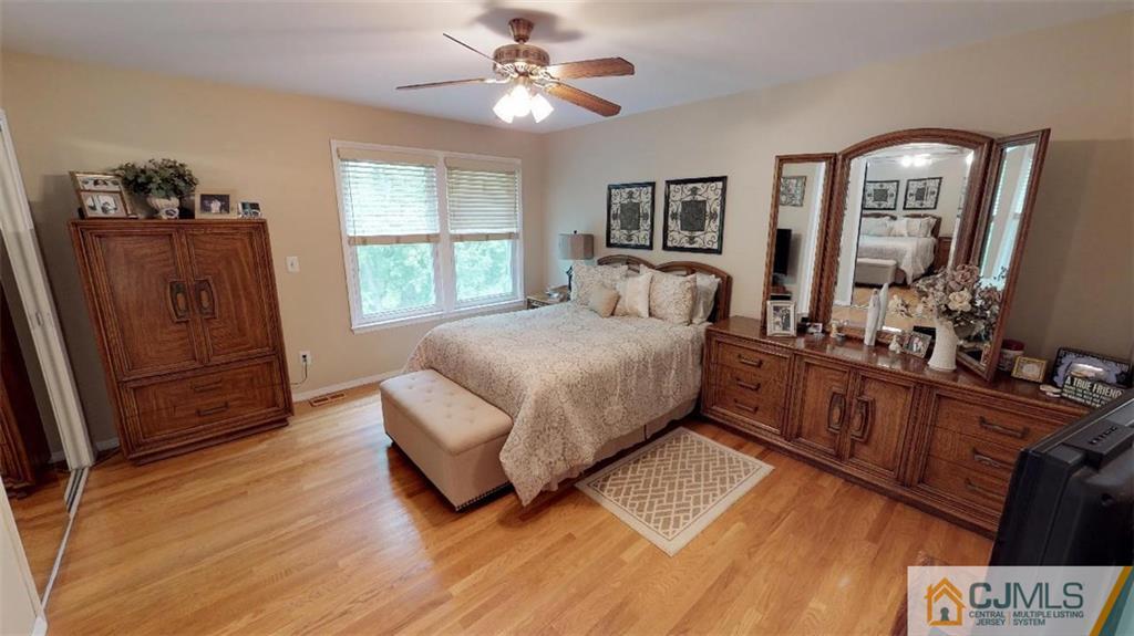 16 Sweet Gum Road Howell, NJ 07731 - Photo 14 of 21 a bedroom with a bed windows and wooden floor