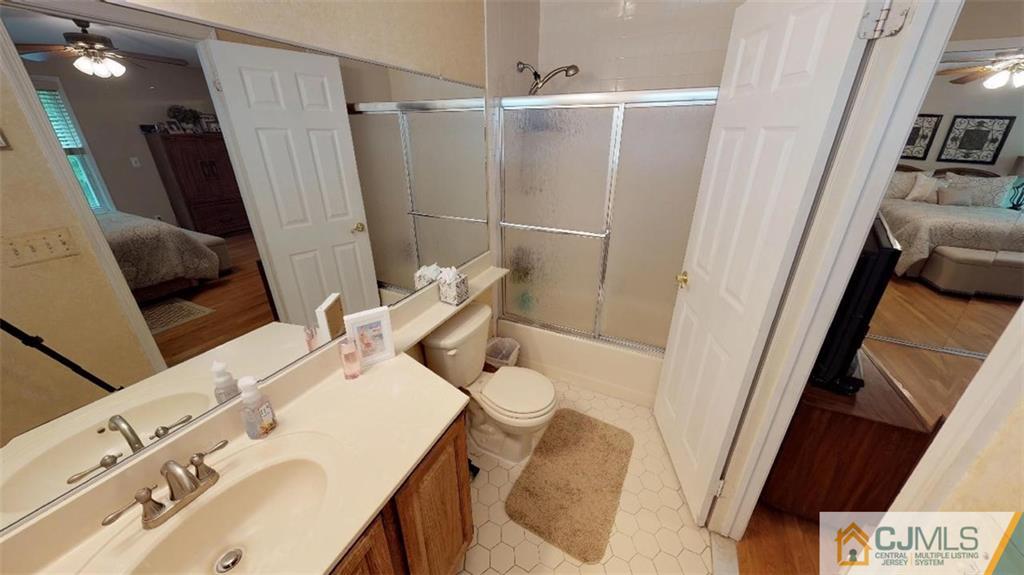 16 Sweet Gum Road Howell, NJ 07731 - Photo 15 of 21 a bathroom with a sink and mirror with toilet