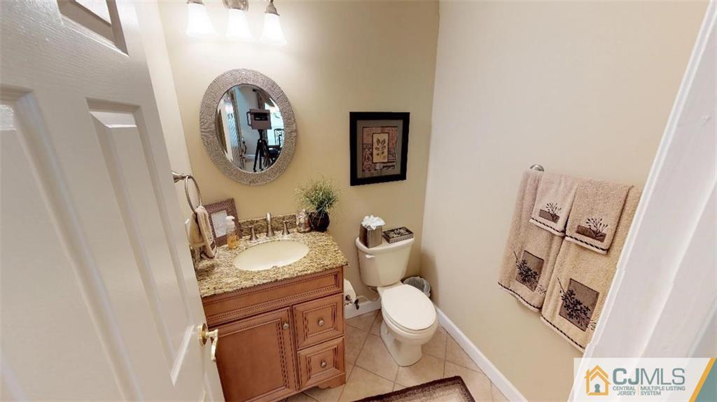 16 Sweet Gum Road Howell, NJ 07731 - Photo 8 of 21 a bathroom with a granite countertop toilet sink and mirror
