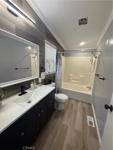 a bathroom with a sink a toilet a mirror and shower