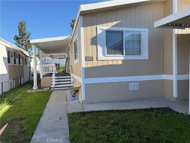 a view of a house with a backyard