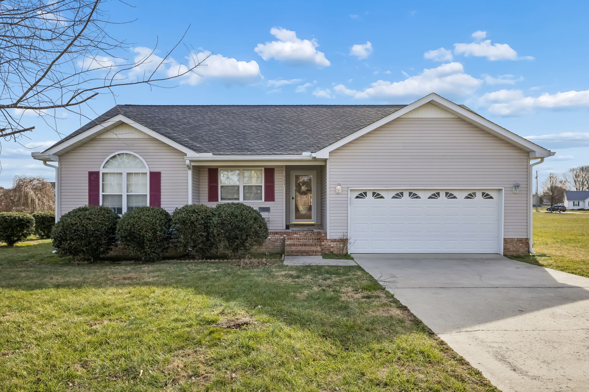 a view of a house with a yard and garage
