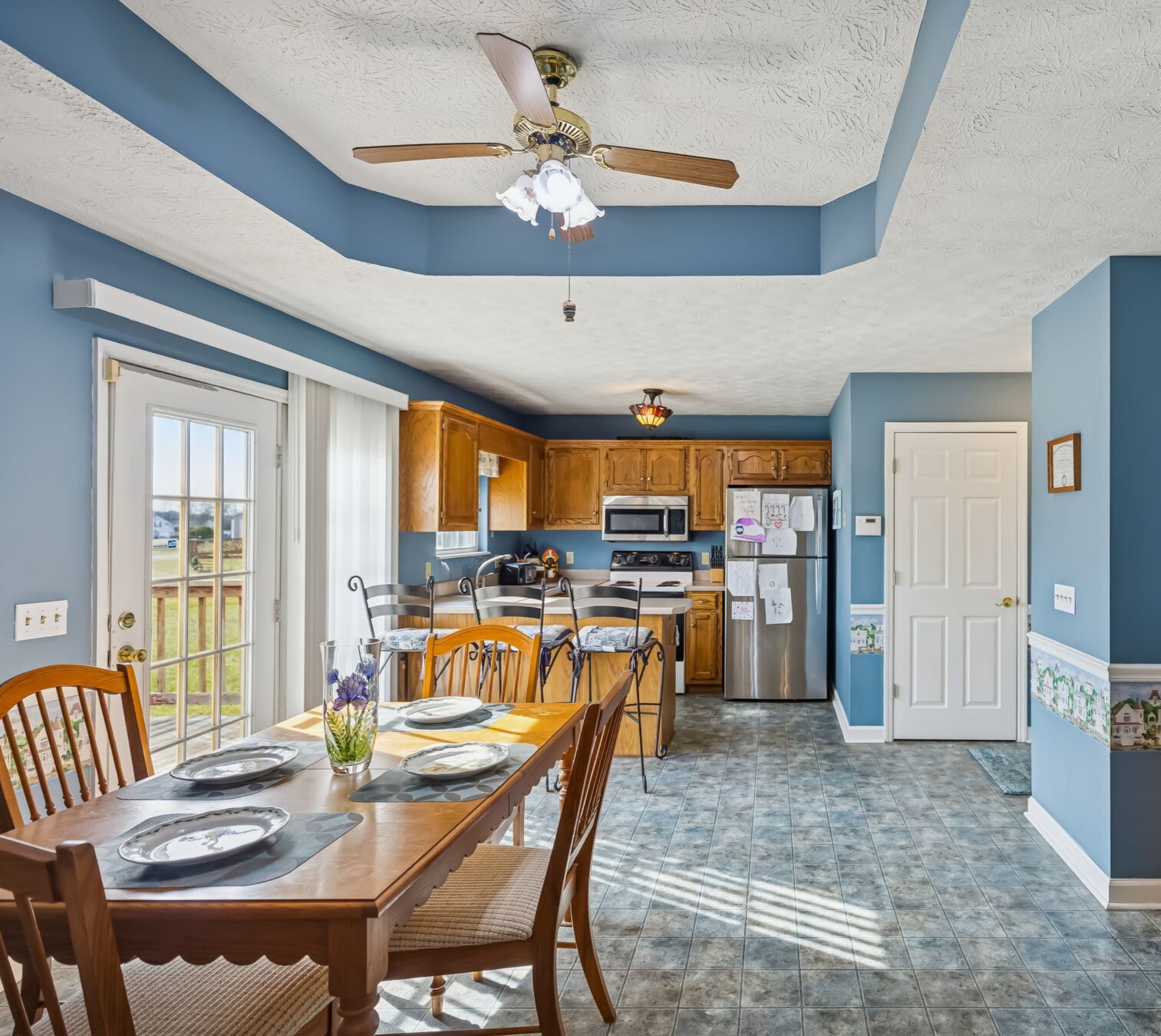 111 Eldon Drive Manchester, TN 37355 - Photo 9 of 24 a dining room with stainless steel appliances kitchen island granite countertop a table chairs and a refrigerator