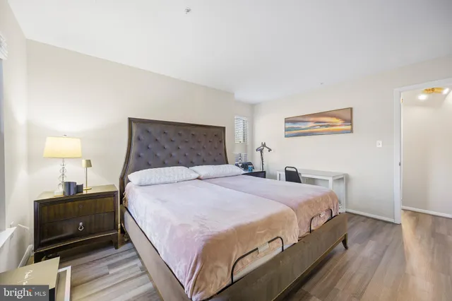 a bedroom with a bed and a night stand