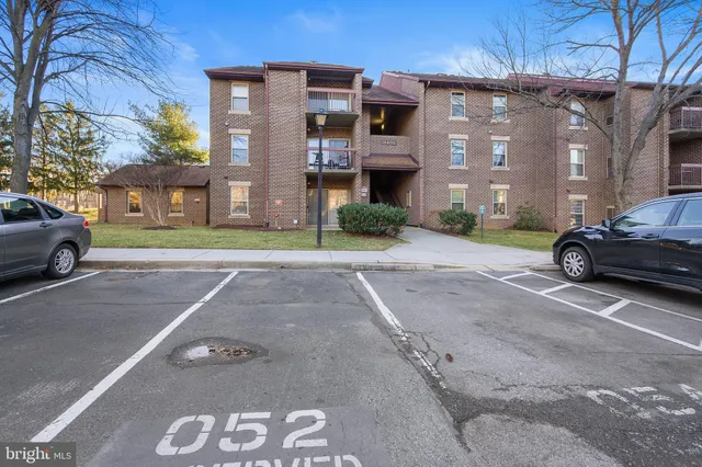 a front view of a building with a yard and a garage