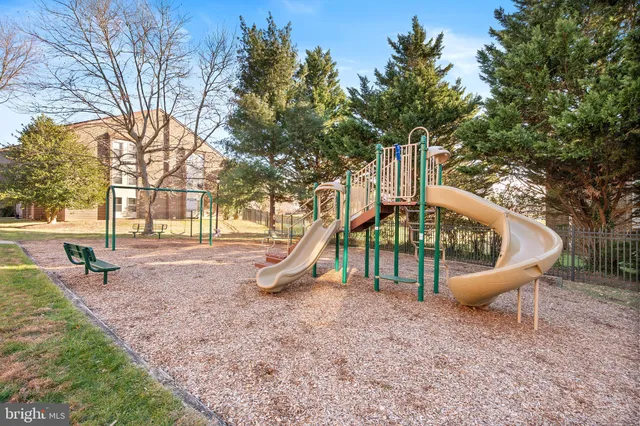 a childrens park with lots of swings and slides