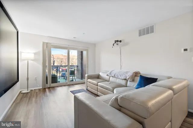 a living room with furniture and a floor to ceiling window