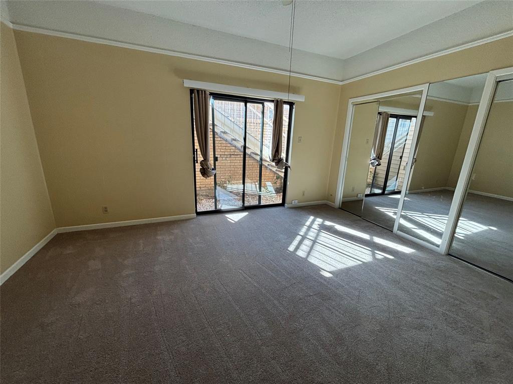 4702 Ranch View Road Fort Worth, TX 76109 - Photo 25 of 40 Carpeted flooring, mirrored sliding closet doors, sliding glass door, crown molding, and painted walls