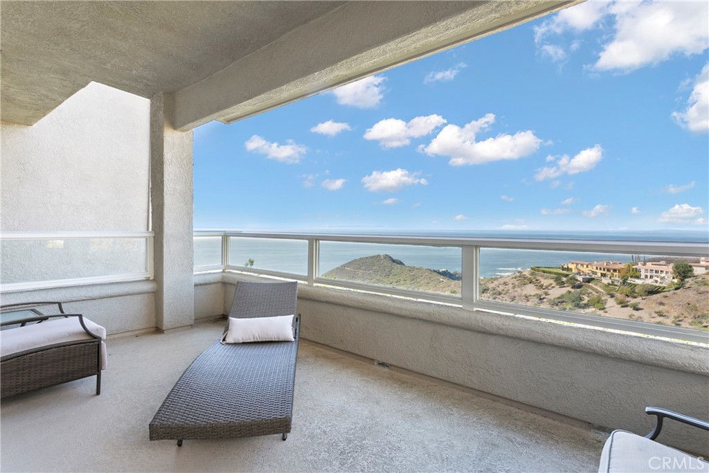 a living room with a bed furniture and a large window