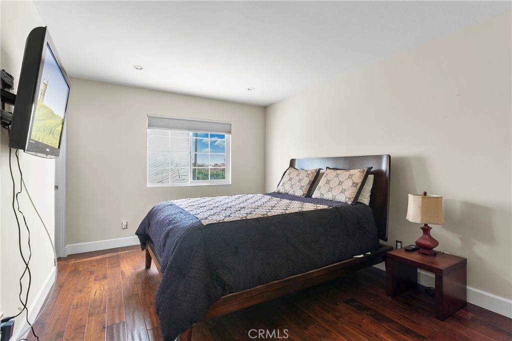 25 St Raphael Laguna Niguel, CA 92677 - Photo 19 of 23 a bed sitting in a bedroom next to a window with wooden floor