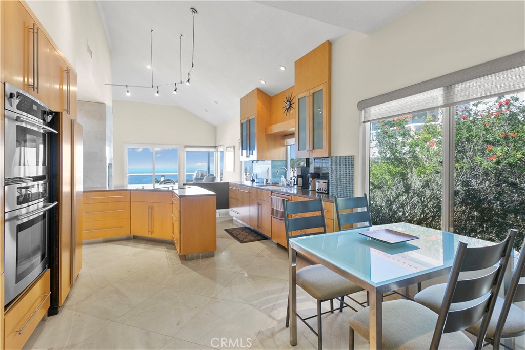 25 St Raphael Laguna Niguel, CA 92677 - Photo 9 of 23 a kitchen with a table chairs sink and cabinets