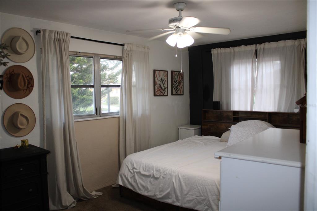 11364 79th Avenue Seminole, FL 33772 - Photo 13 of 28 a bedroom with a bed and a window