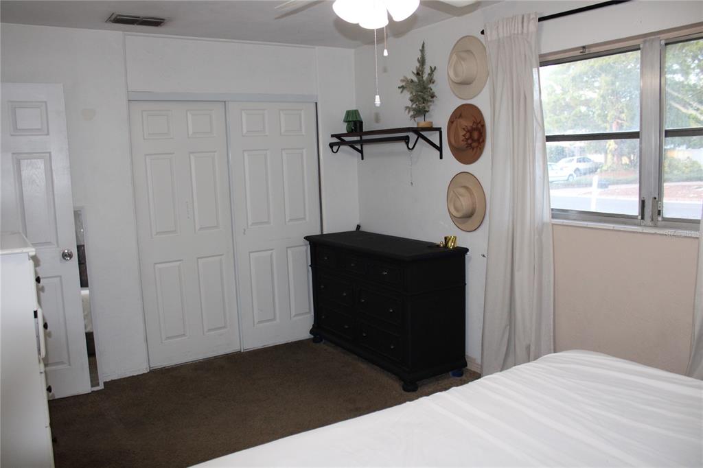 11364 79th Avenue Seminole, FL 33772 - Photo 15 of 28 a bedroom with a bed and a window