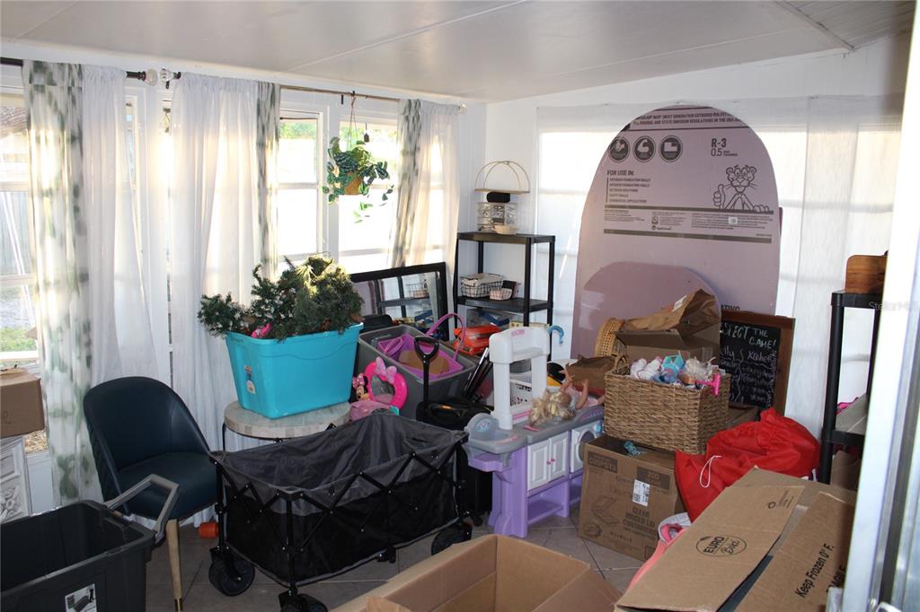 11364 79th Avenue Seminole, FL 33772 - Photo 20 of 28 a view of a workspace with furniture and a window
