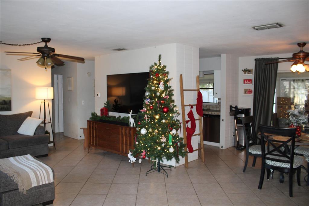 11364 79th Avenue Seminole, FL 33772 - Photo 2 of 28 a living room with furniture and a flat screen tv