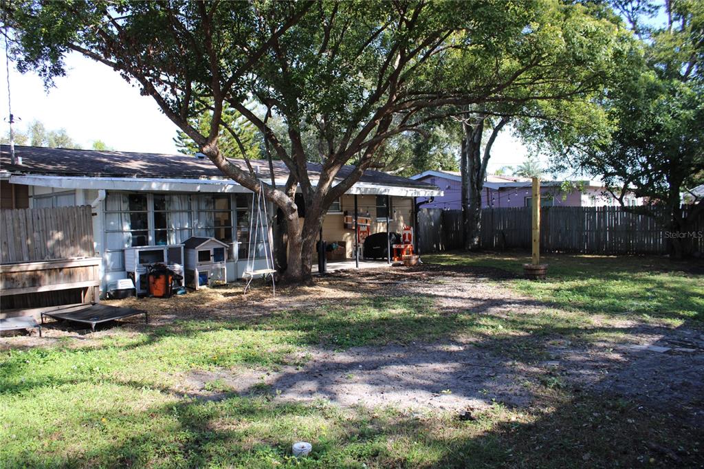 11364 79th Avenue Seminole, FL 33772 - Photo 25 of 28 a front view of a house with garden and trees
