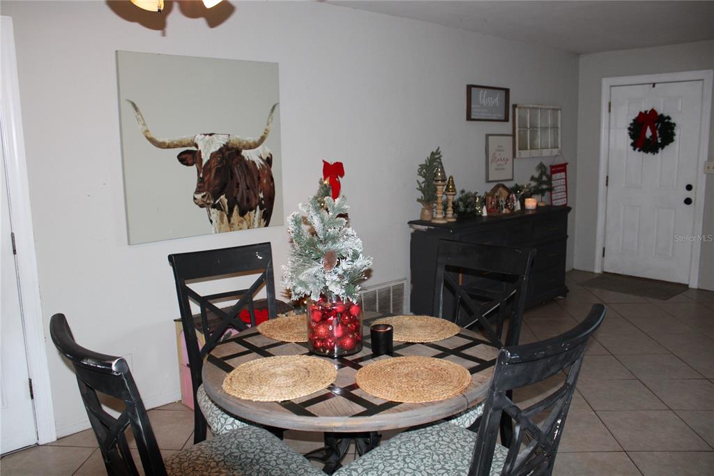 11364 79th Avenue Seminole, FL 33772 - Photo 8 of 28 a view of a dining room with furniture and chandelier