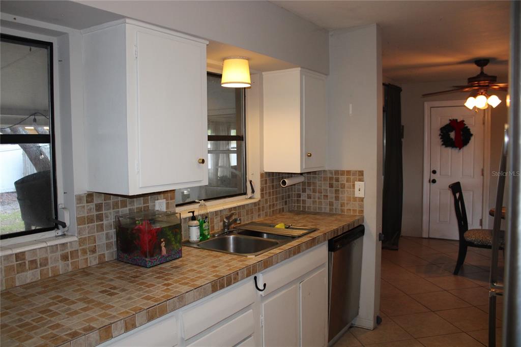 11364 79th Avenue Seminole, FL 33772 - Photo 10 of 28 a kitchen with a sink stove and cabinets