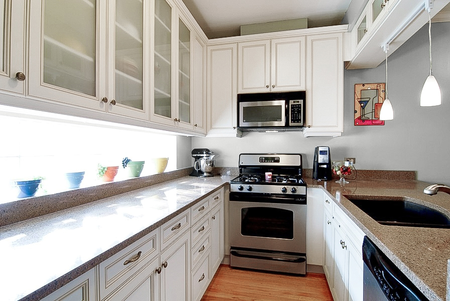 1722 North Bissell Street Chicago, IL 60614 - Photo 4 of 8 a kitchen with stainless steel appliances granite countertop white cabinets a stove top oven a sink and dishwasher