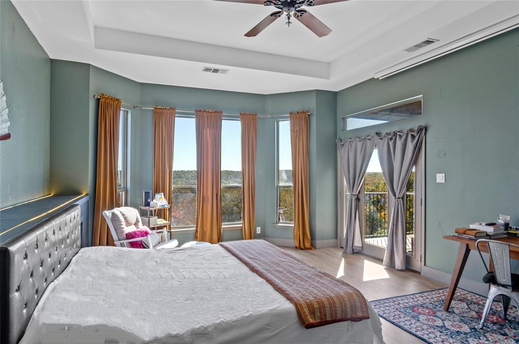 396 Ranchview Court Bowie, TX 76230 - Photo 11 of 40 a bedroom with a bed and large windows