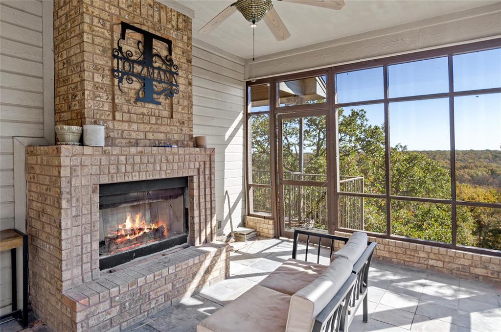 396 Ranchview Court Bowie, TX 76230 - Photo 17 of 40 a living room with a fireplace furniture and a large window