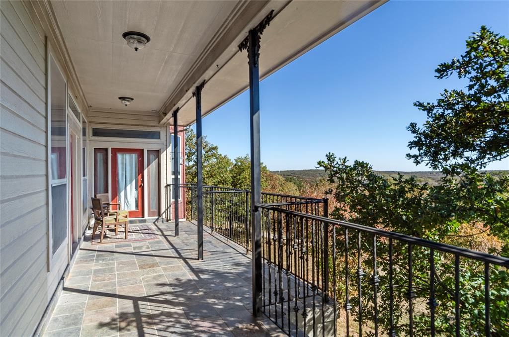 396 Ranchview Court Bowie, TX 76230 - Photo 18 of 40 a view of balcony with wooden floor and bench